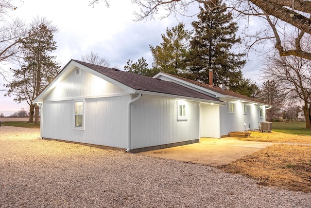 view of home's exterior with a patio area and central AC unit