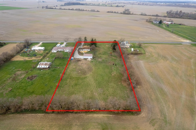 birds eye view of property with a rural view