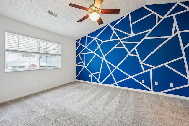 carpeted empty room featuring a textured ceiling and ceiling fan