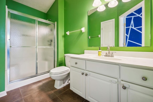 bathroom featuring vanity, tile patterned flooring, toilet, walk in shower, and a textured ceiling