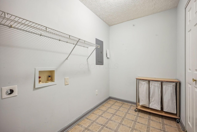 laundry room with hookup for an electric dryer, hookup for a washing machine, a textured ceiling, and electric panel