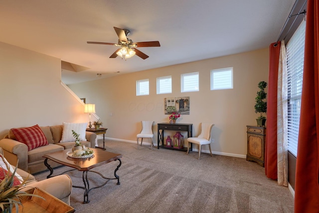 carpeted living room with ceiling fan