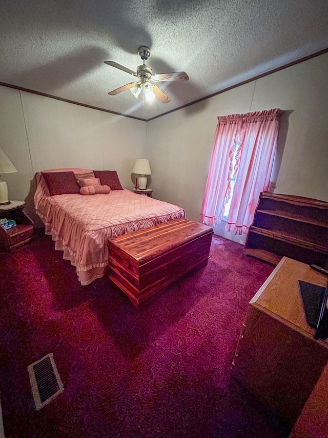 carpeted bedroom with ceiling fan and a textured ceiling