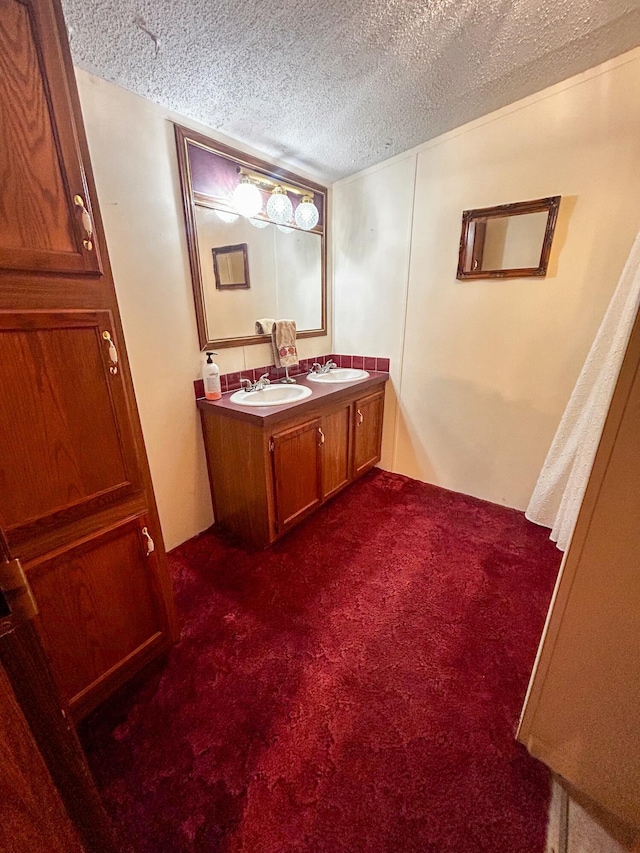 bathroom featuring vanity and a textured ceiling