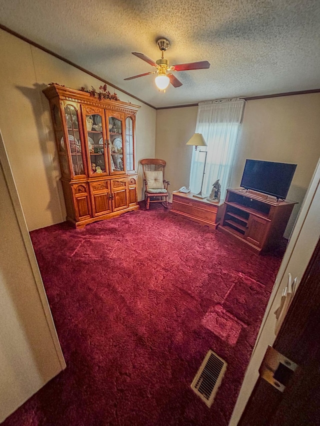 unfurnished room featuring carpet flooring, a textured ceiling, and ceiling fan