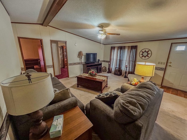 carpeted living room with a textured ceiling, vaulted ceiling with beams, plenty of natural light, and ceiling fan