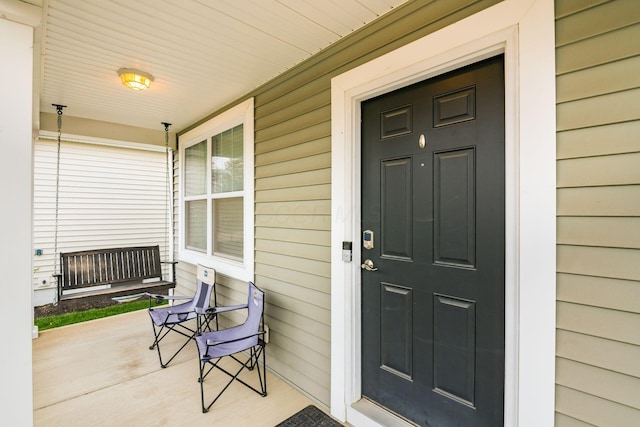 property entrance with covered porch