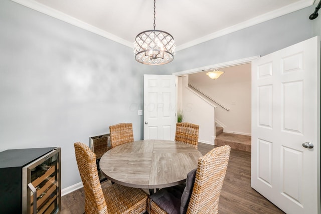 dining room with ornamental molding, an inviting chandelier, and dark wood-type flooring