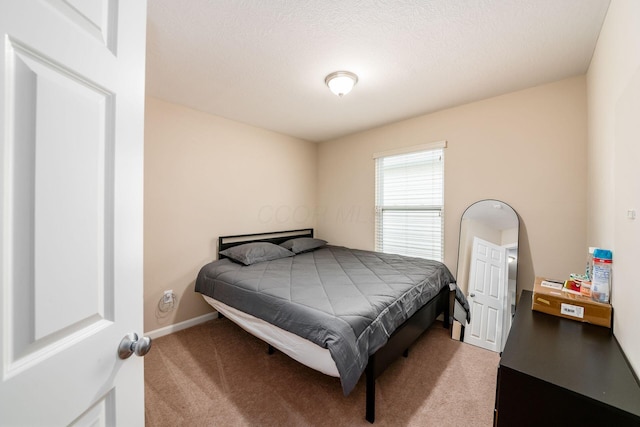 carpeted bedroom with a textured ceiling