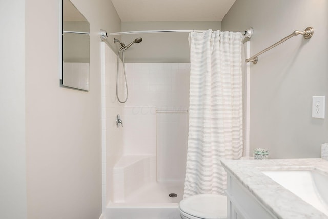 bathroom with vanity, toilet, and walk in shower