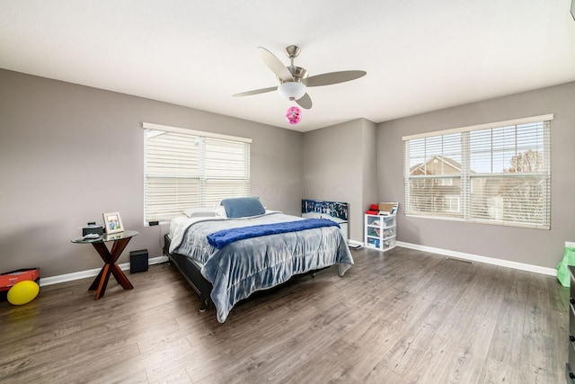 bedroom with ceiling fan and dark wood-type flooring