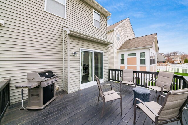 wooden deck with a grill