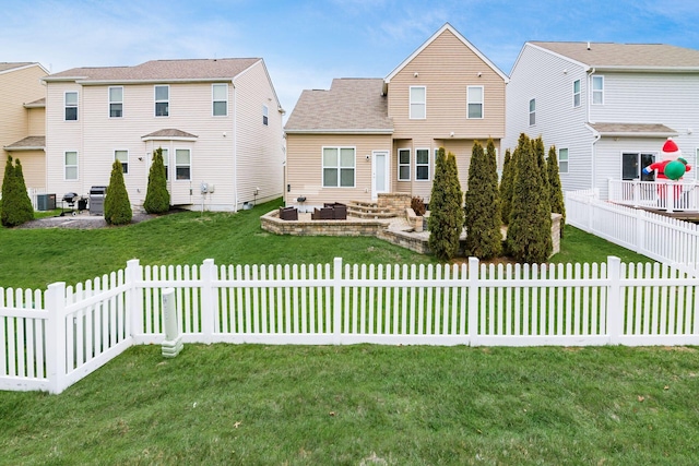 rear view of property with a lawn, central AC unit, and a patio