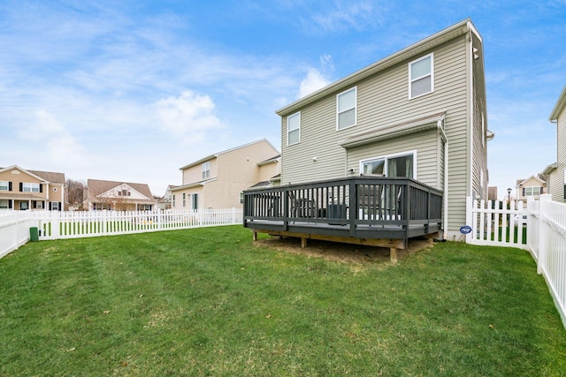 back of house featuring a yard and a wooden deck