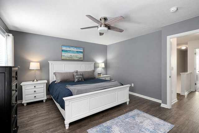 bedroom with ceiling fan, dark wood-type flooring, and a textured ceiling