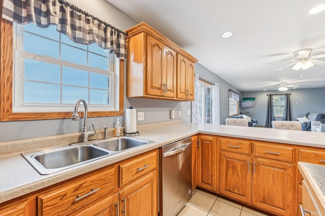 kitchen with ceiling fan, stainless steel dishwasher, a wealth of natural light, and sink