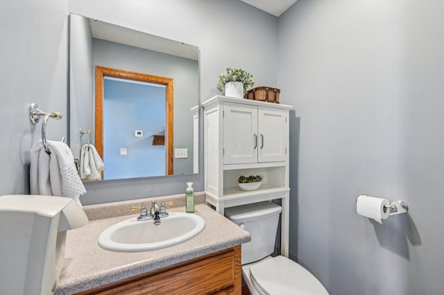 bathroom featuring vanity and toilet