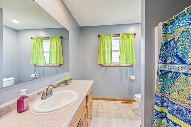 bathroom featuring vanity and toilet