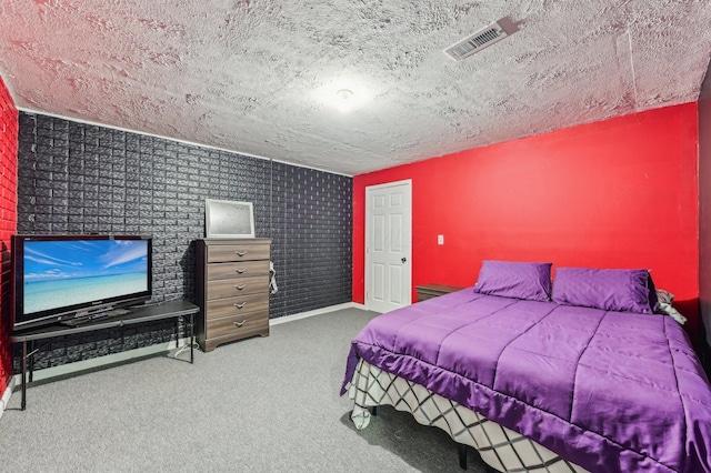 carpeted bedroom featuring a textured ceiling