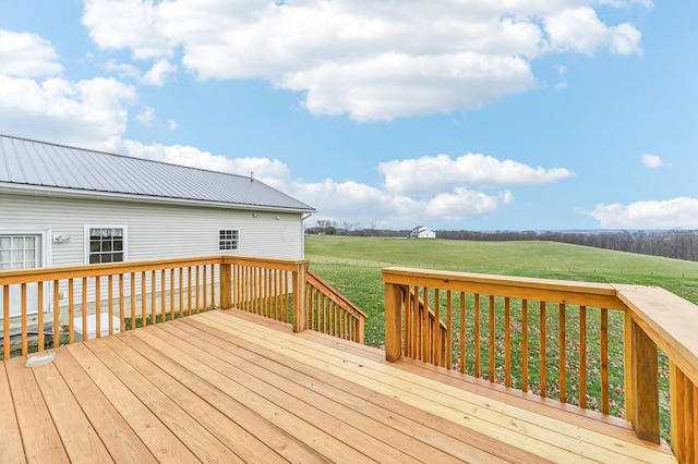 wooden deck with a lawn and a rural view