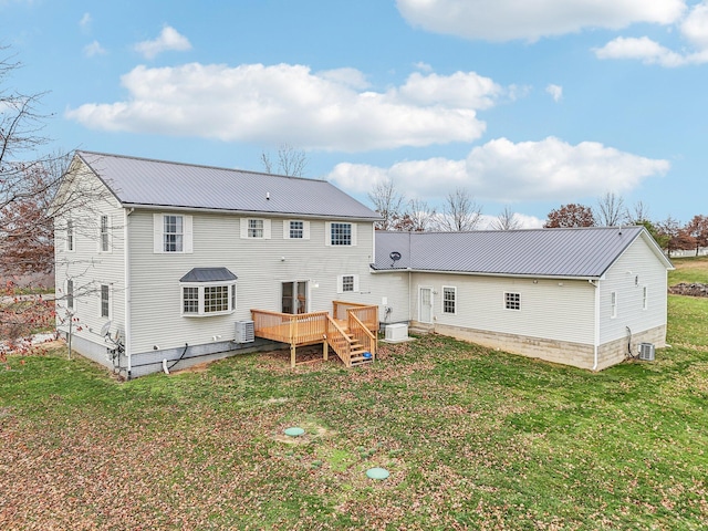 rear view of house with a yard, central AC unit, and a deck