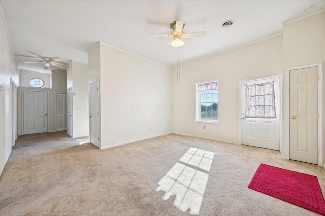 unfurnished room featuring light carpet, crown molding, and ceiling fan