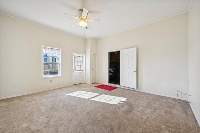 spare room with light carpet, ceiling fan, and ornamental molding