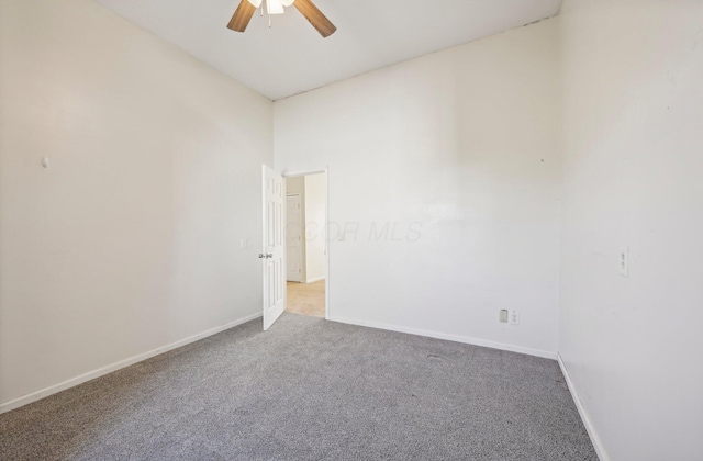 spare room featuring light carpet and ceiling fan