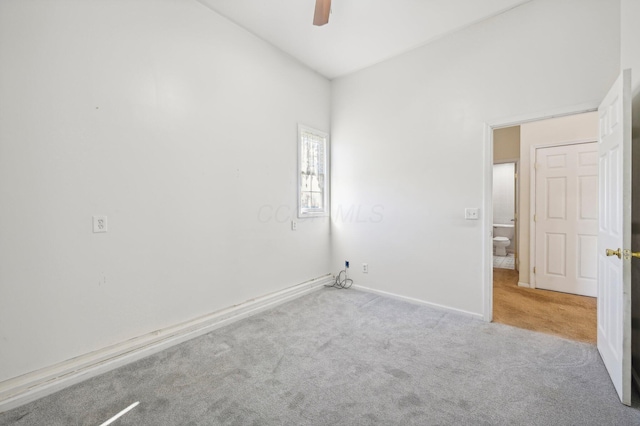 carpeted empty room featuring ceiling fan and lofted ceiling