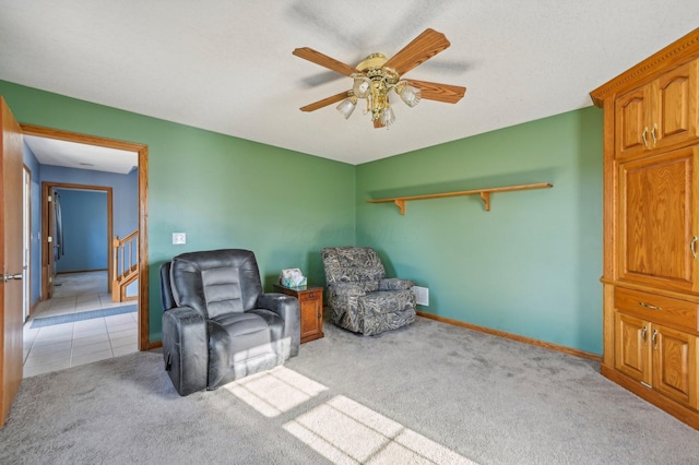 sitting room with ceiling fan and light colored carpet