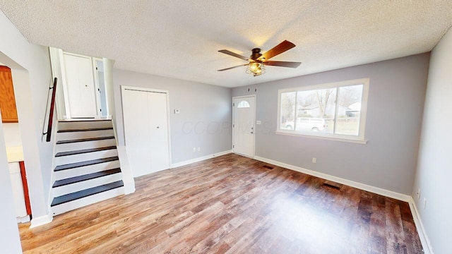 interior space featuring ceiling fan, light hardwood / wood-style flooring, and a textured ceiling