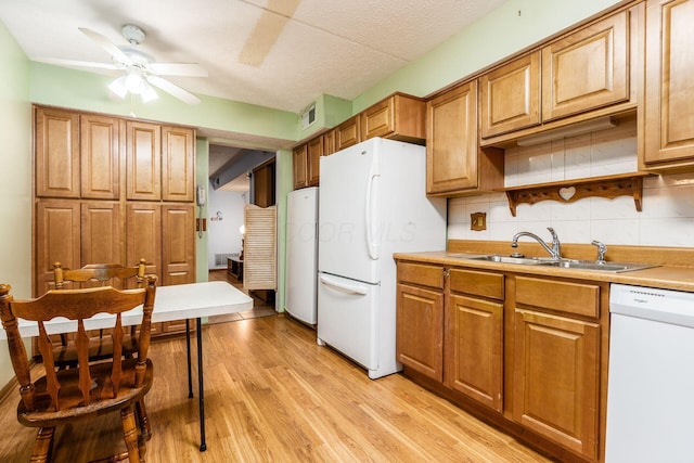 kitchen with light wood-type flooring, tasteful backsplash, white appliances, ceiling fan, and sink