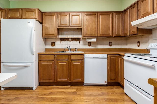 kitchen with white appliances, ventilation hood, sink, light hardwood / wood-style flooring, and decorative backsplash