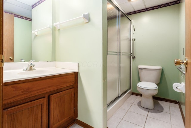 bathroom featuring toilet, vanity, tile patterned floors, and walk in shower