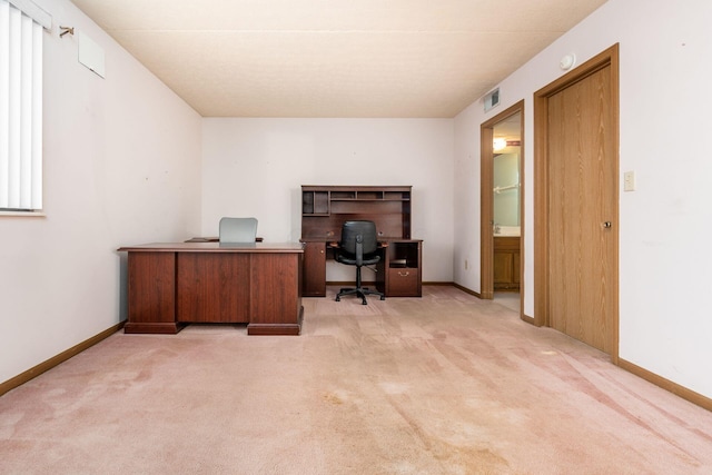 home office featuring light carpet and a healthy amount of sunlight