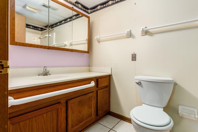 bathroom featuring tile patterned floors, vanity, a textured ceiling, and toilet