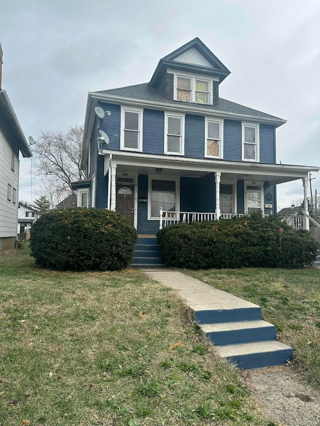 view of front of home featuring a front yard and a porch