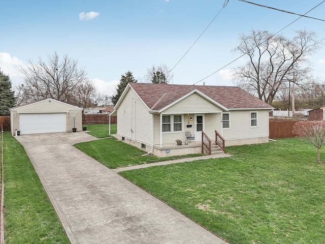 view of front facade featuring a front yard, a porch, an outbuilding, and a garage