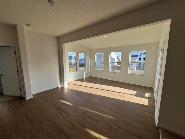 unfurnished living room featuring dark hardwood / wood-style flooring and a textured ceiling