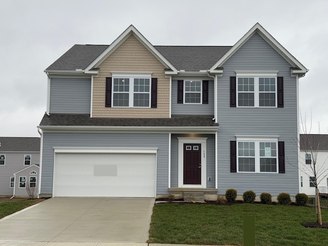 view of front facade featuring a garage and a front lawn