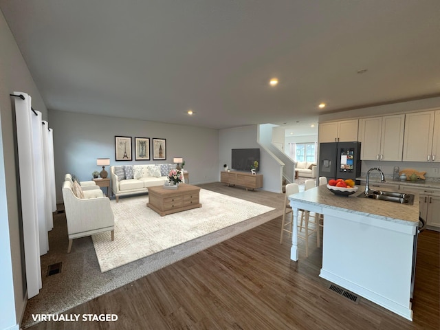 living room with dark wood-type flooring and sink