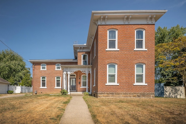 italianate home featuring a front yard