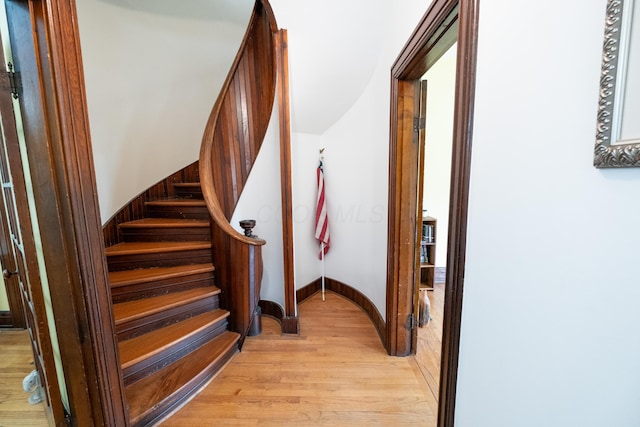 stairs featuring hardwood / wood-style flooring