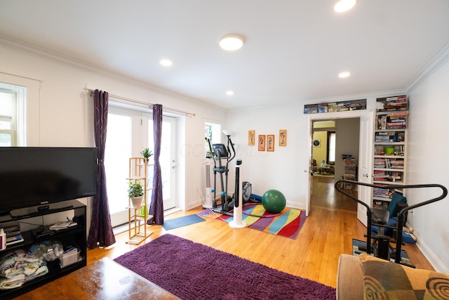 workout room featuring hardwood / wood-style flooring and ornamental molding