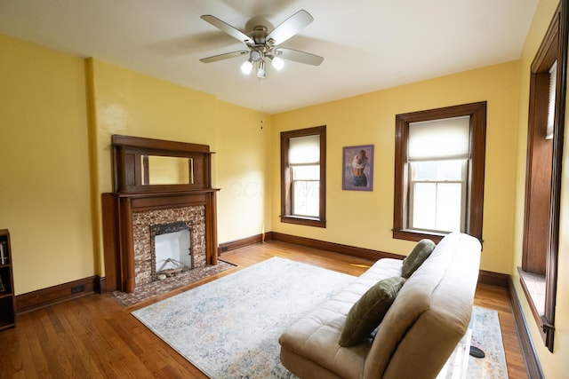 living room with a wealth of natural light, ceiling fan, and hardwood / wood-style flooring