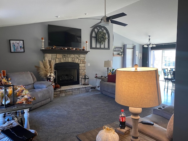 living room featuring ceiling fan with notable chandelier, a stone fireplace, lofted ceiling, and carpet floors