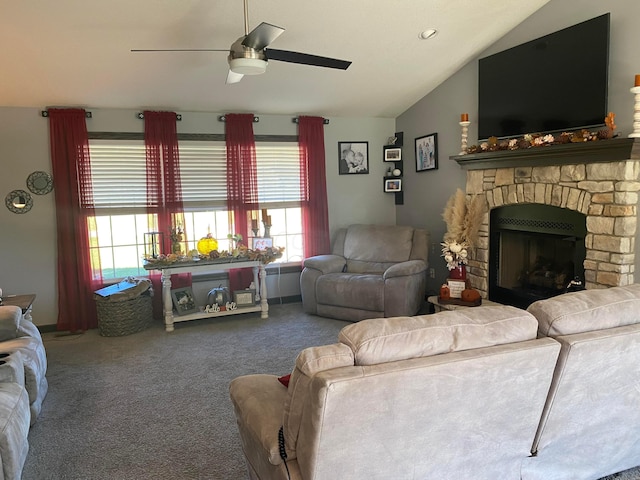 living room featuring carpet, vaulted ceiling, ceiling fan, and a stone fireplace