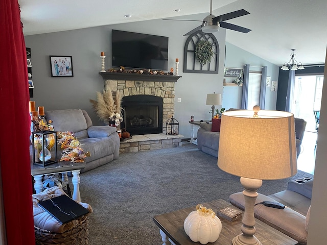 living room with ceiling fan with notable chandelier, carpet floors, a fireplace, and vaulted ceiling