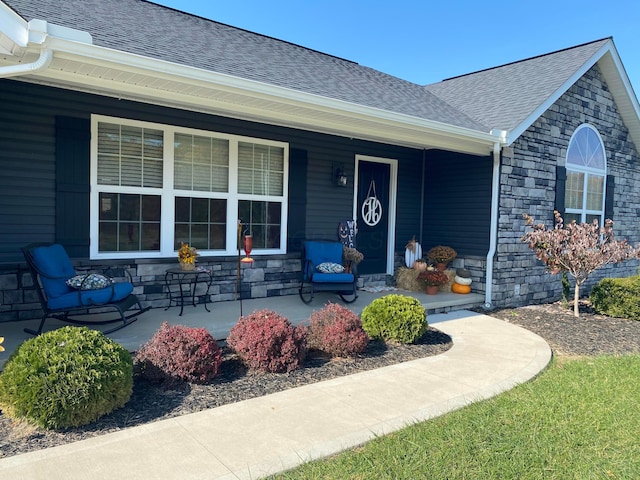 view of exterior entry with covered porch