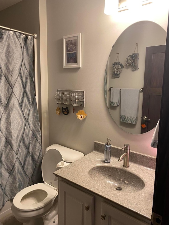 bathroom featuring a shower with shower curtain, vanity, and toilet